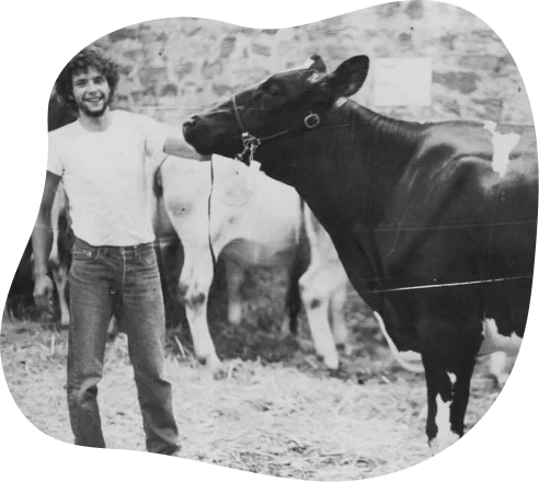 Archive photo of a farmer with a cow in a blob mask