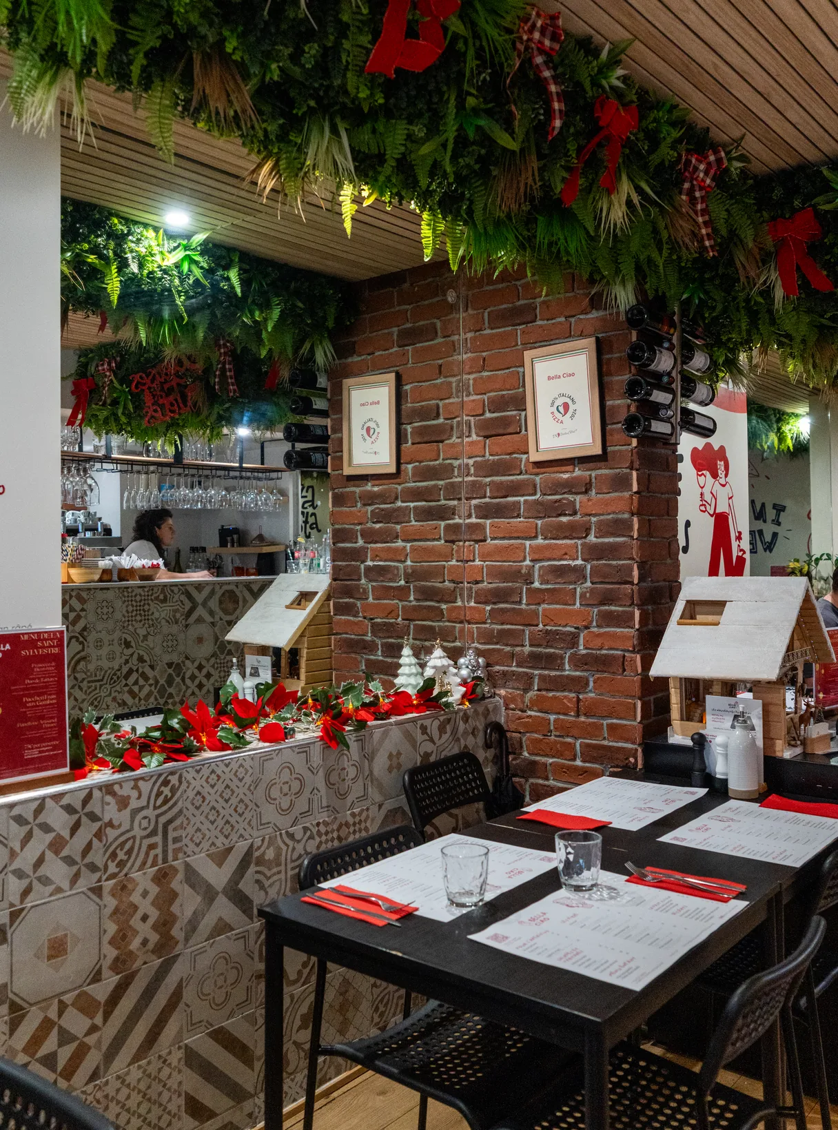 The Californie dining room: brick wall, cement tiles and tables laid with the Bella Ciao placemats