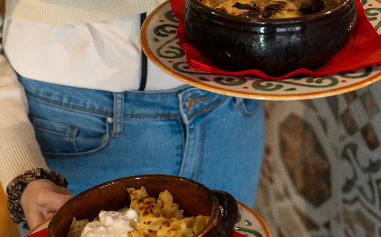Pasta al forno served in terracotta on patterned plates