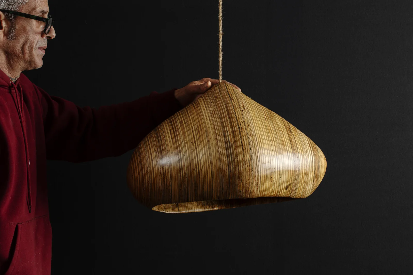 Salvatore holding a layered-wood lamp