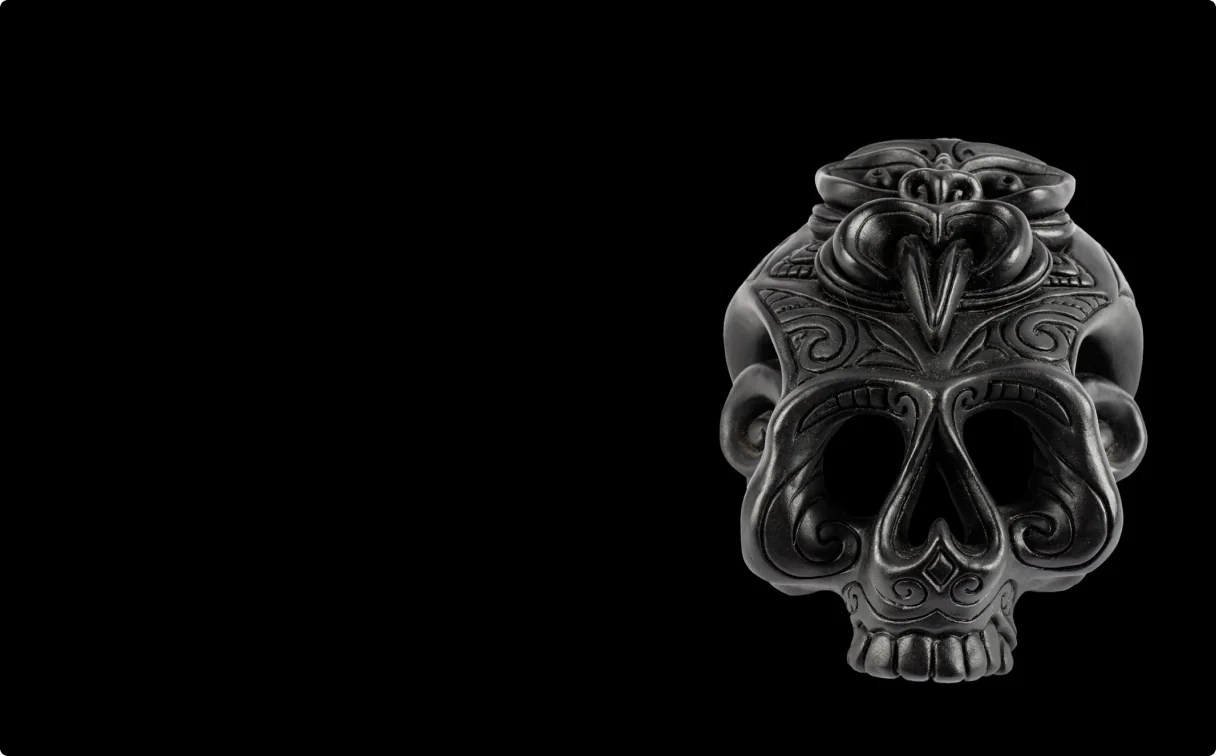 Teschio Manaia, a carved and burnished wooden skull